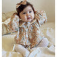 Floral organic cotton long sleeved girl romper